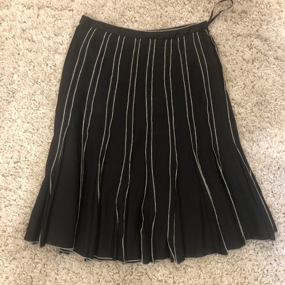 Black skirt with white threaded detailing.